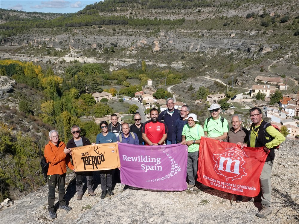 Participantes en la presentación del Reto Ibérico con las pancartas de Rewilding Spain y la Federación de Montaña, con Molinos de Papel al fondo